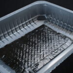 Absorbent pad placed in a clear food packaging tray